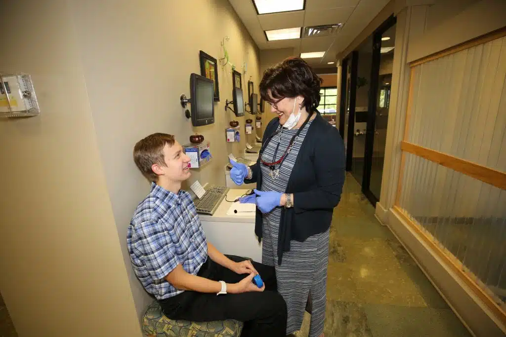Dr. Mary Cay Koen fitting a patient for Invisalign Teen