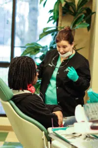 Do You Get Braces On Your First Orthodontist Appointment? Patient Asking Questions about the treatment plan while a nurse answers, joyfully.