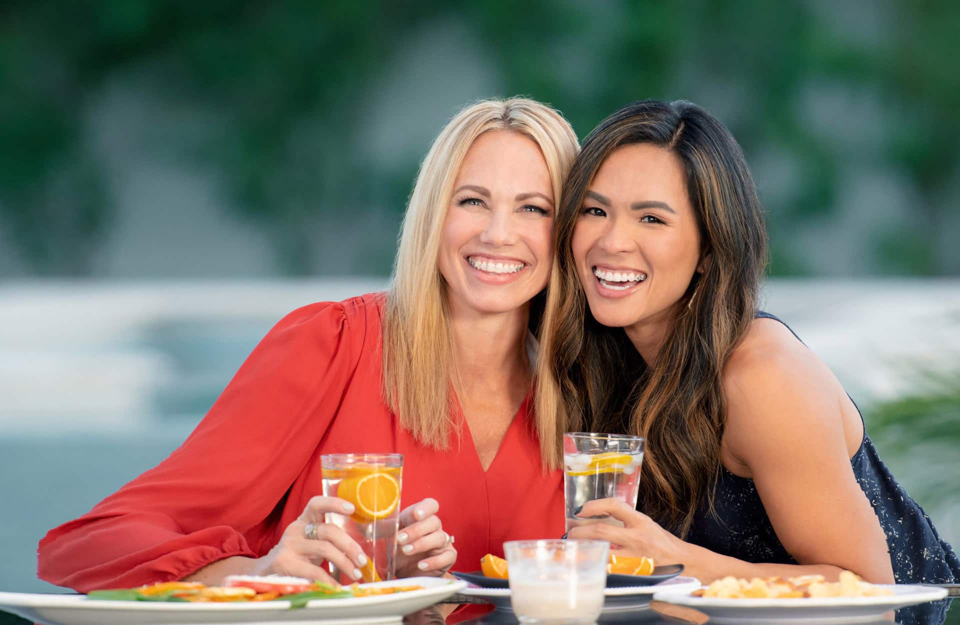 two adult females enjoying lunch while wearing Damon clear braces