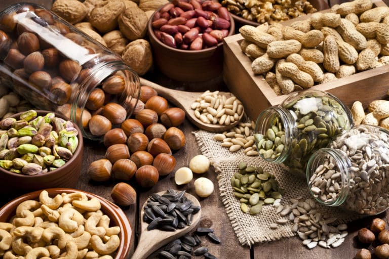 a table with many plates filled with grains and nuts